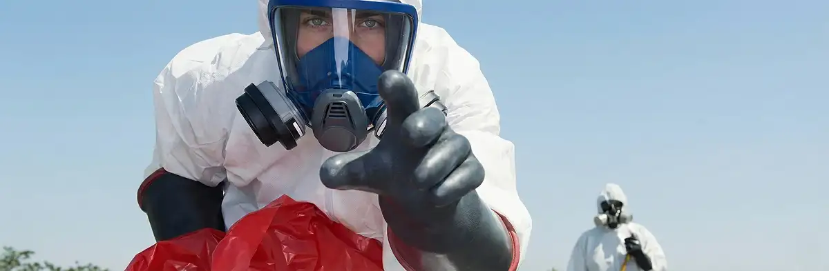 sewage clean up technician wearing protective gear handling biohazard materials in Oklahoma City, OK